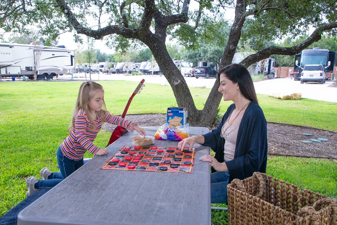 sunset-ranch-rv-park-mother-and-daughter-playing-checkers